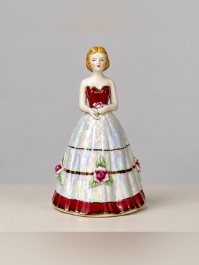 Porcelain Victorian style figurine dressed in an opalescent red and white Dress